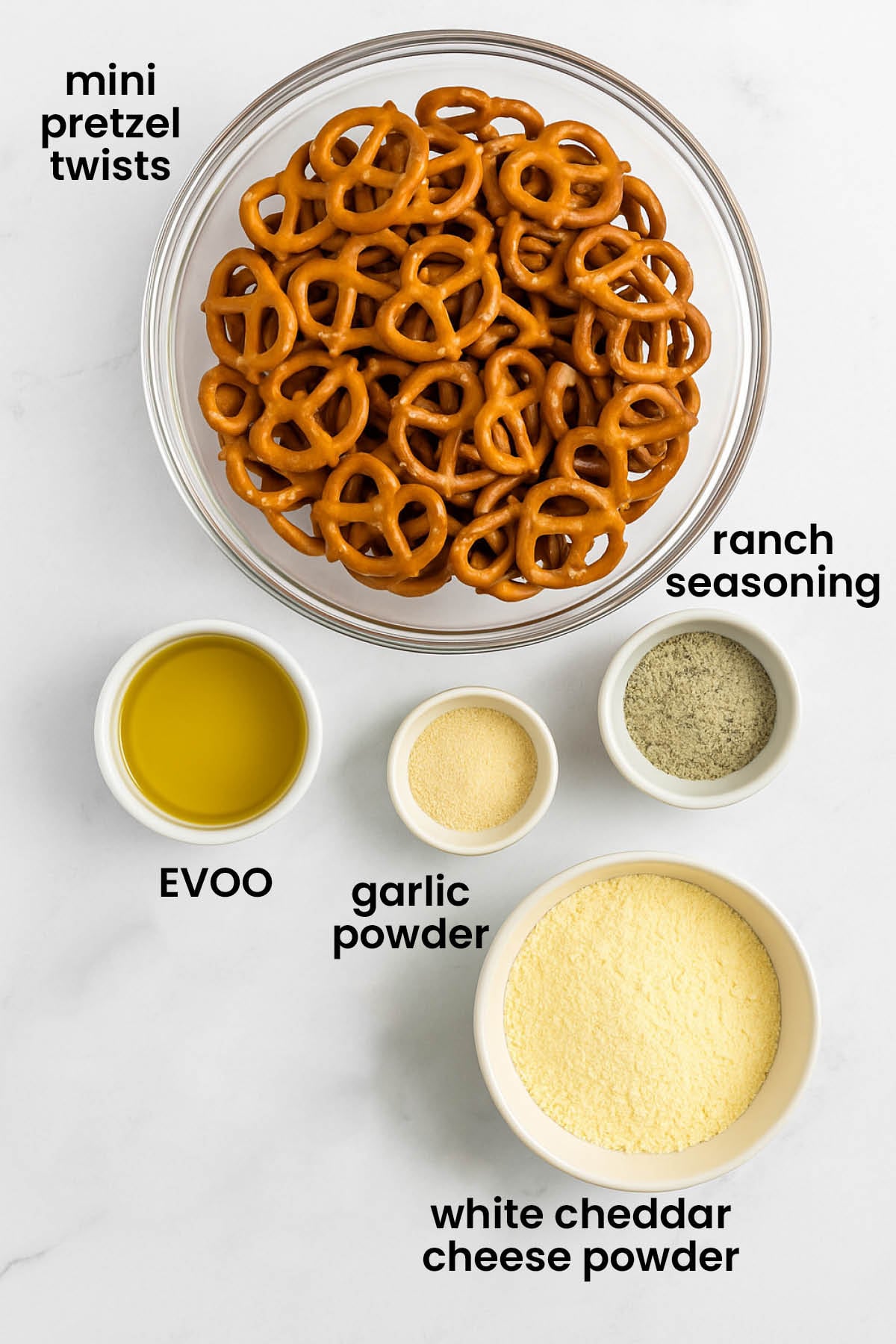 individual ingredients for garlic ranch pretzels with white cheddar laid out against a white background.