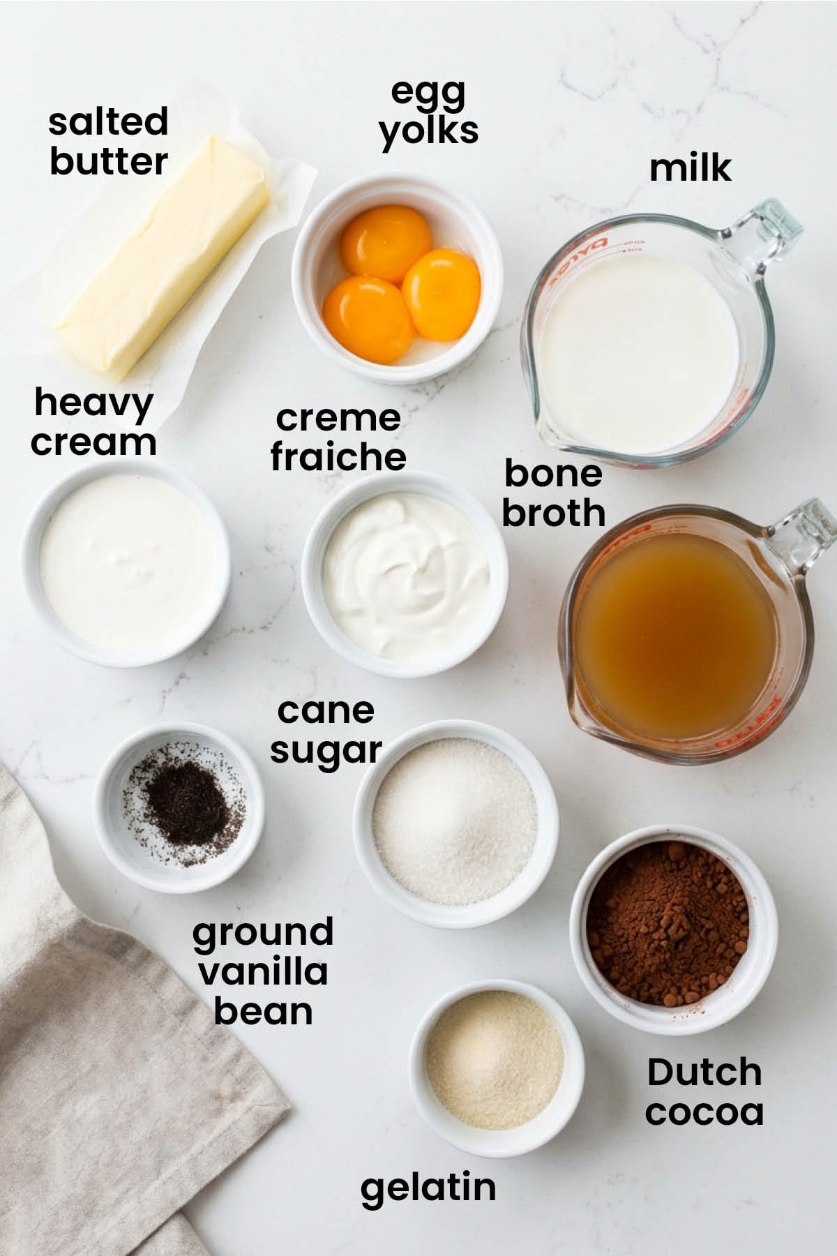 individual ingredients for chocolate protein pudding with bone broth laid out against a white background.