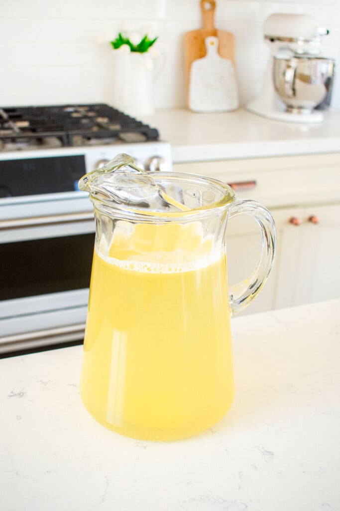 organic homemade lemonade in a glass pitcher on a kitchen counter.