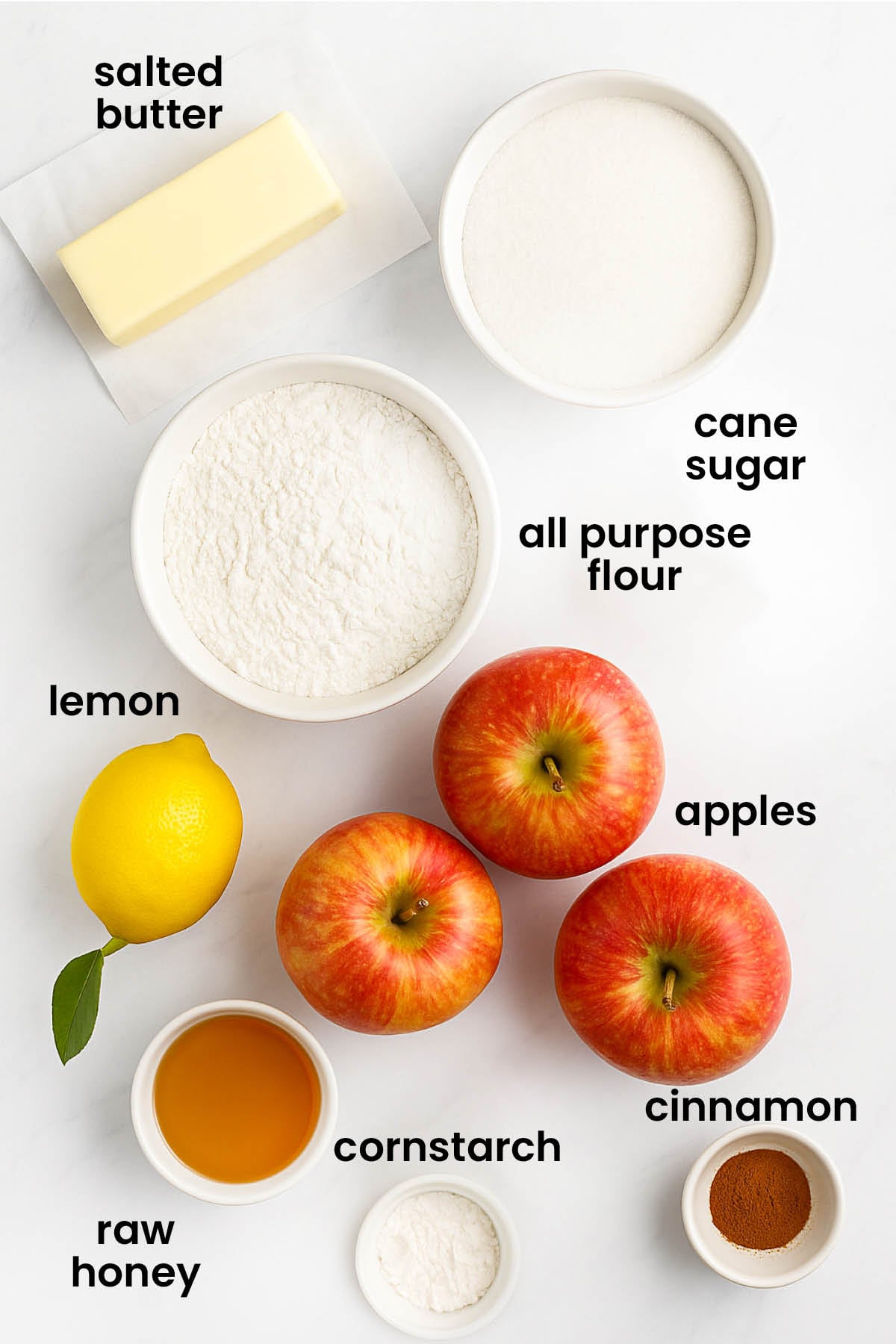 individual ingredients for honey lemon apple pie laid out against a white background.