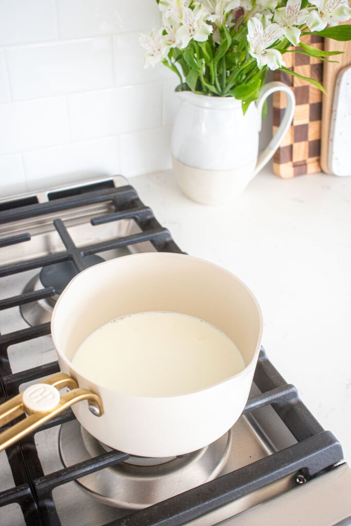 small pot with milk and sugar on the stovetop.