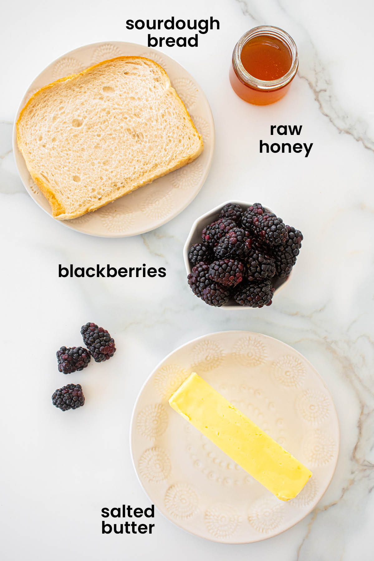 individual ingredients for blackberry honey butter toast laid out against a white background.