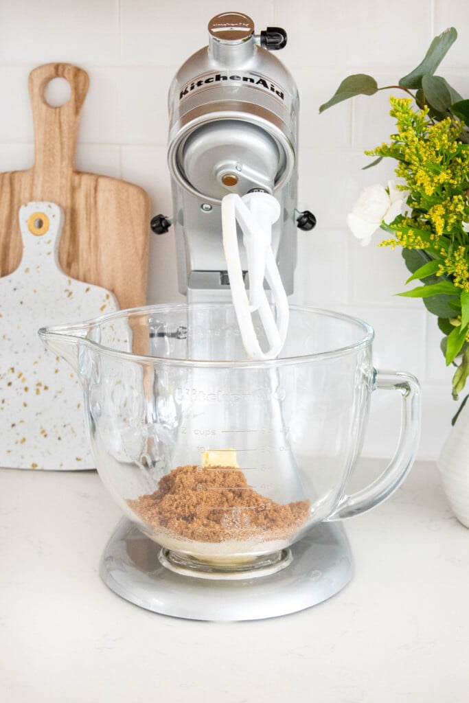 butter, sugar, and brown sugar in a stand mixer on the countertop.