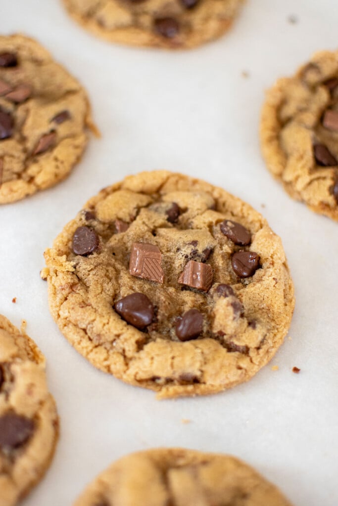 coffee creamer cookies on white parchment paper on a baking sheet.