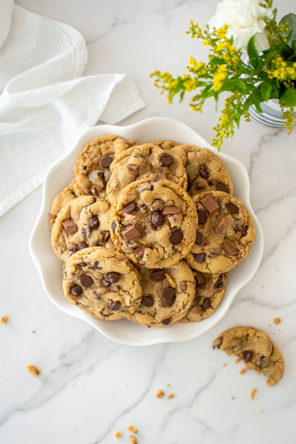 plate of coffee creamer cookies on a white marble countertop.
