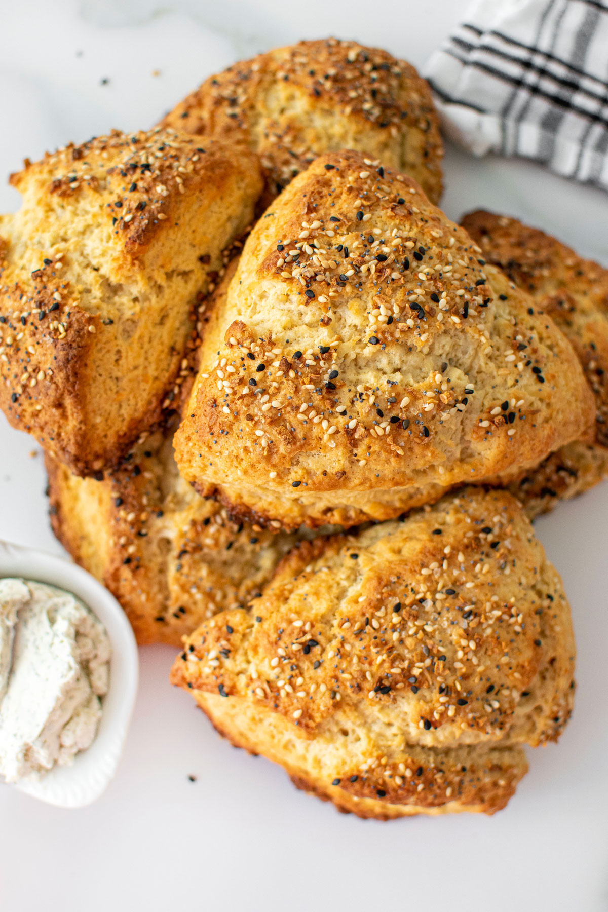 everything bagel scones cooling on a marble countertop.