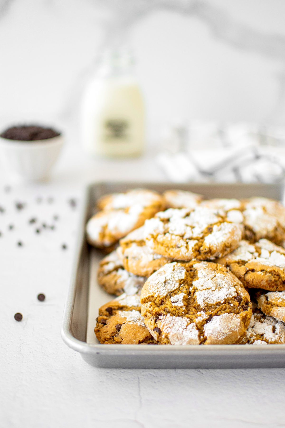 chocolate chip crinkle cookies on a baking sheet.