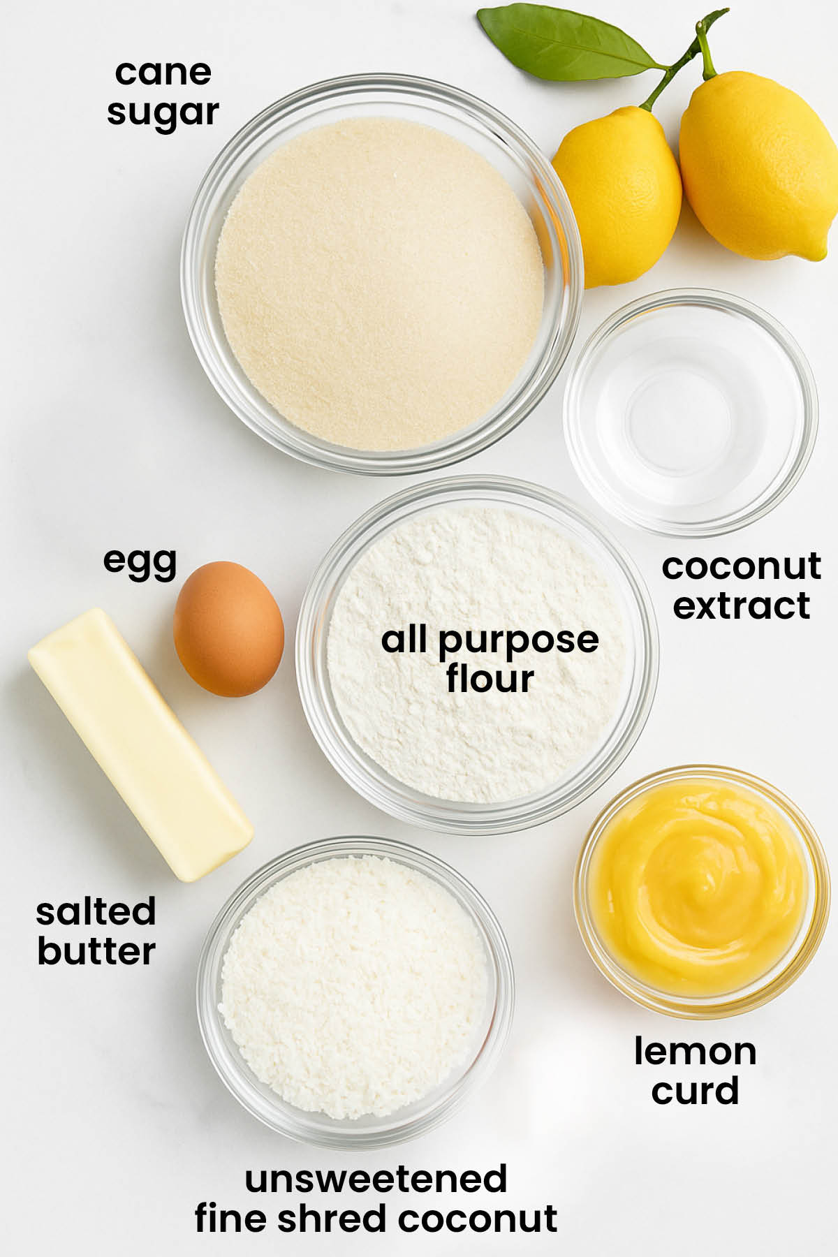individual ingredients for lemon curd coconut thumbprint cookies laid out against a white background.