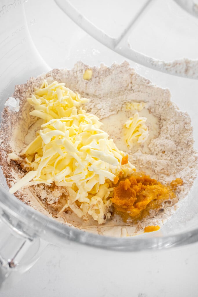 ingredients for eggless pumpkin spice scones in a glass mixing bowl.