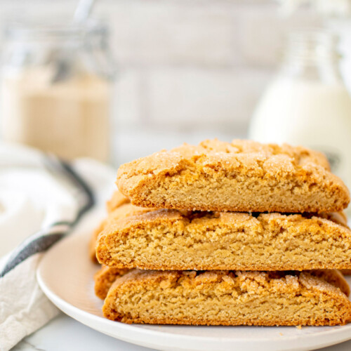 kamut flour biscotti on a plage on a white marble counter with fresh flowers.