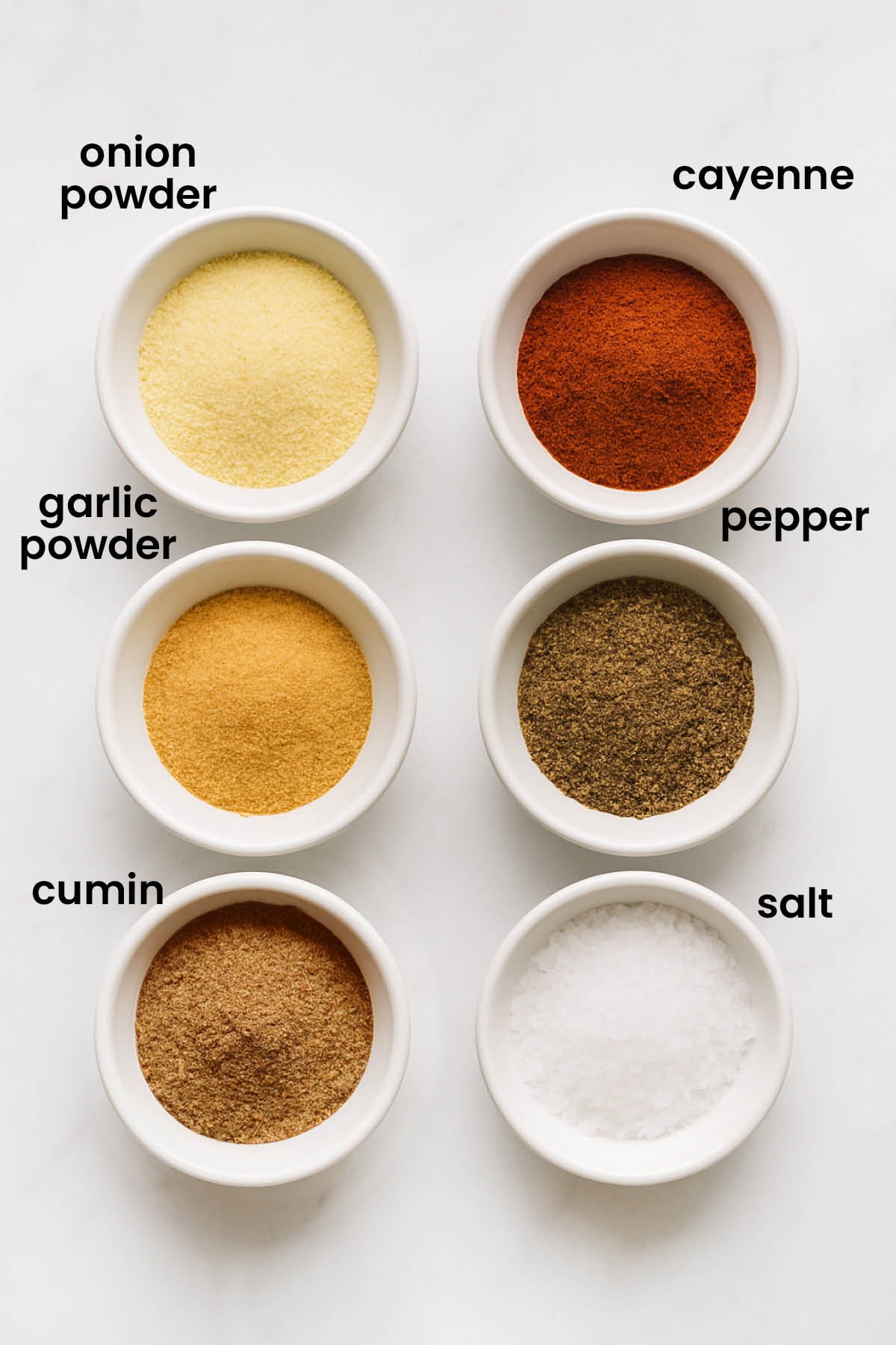 individual ingredients for organic homemade taco seasoning laid out against a white background.