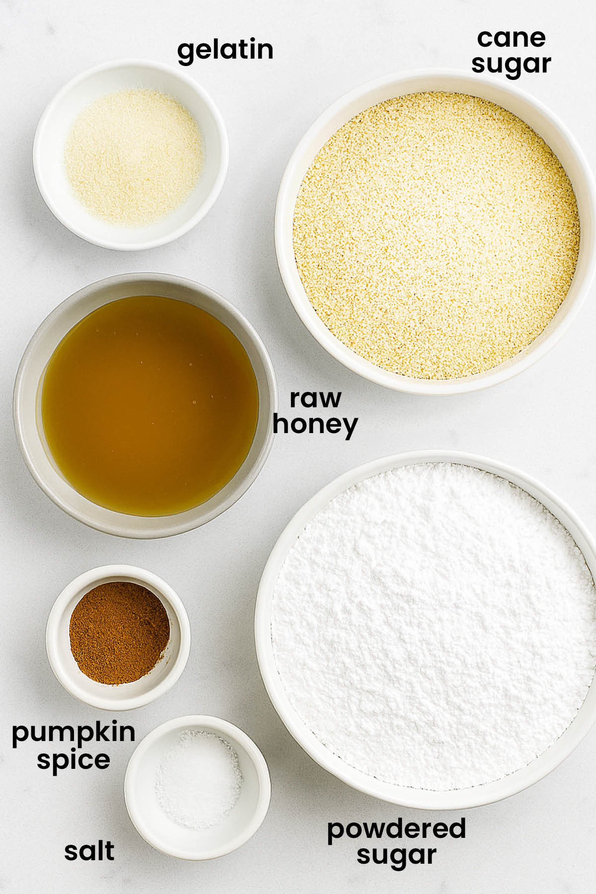 individual ingredients for pumpkin spice marshmallows without corn syrup laid out against a white background.