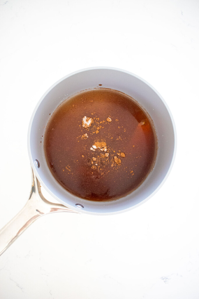 homemade pumpkin spice marshmallow ingredients in a pot on a marble countertop.