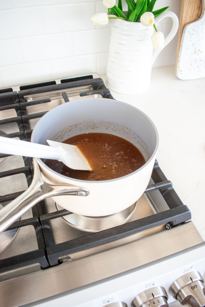 homemade pumpkin spice marshmallows being cooked in a pot on the stovetop.