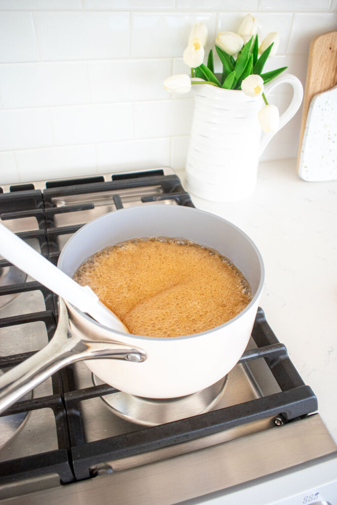 homemade pumpkin spice marshmallows being cooked in a pot on the stovetop.