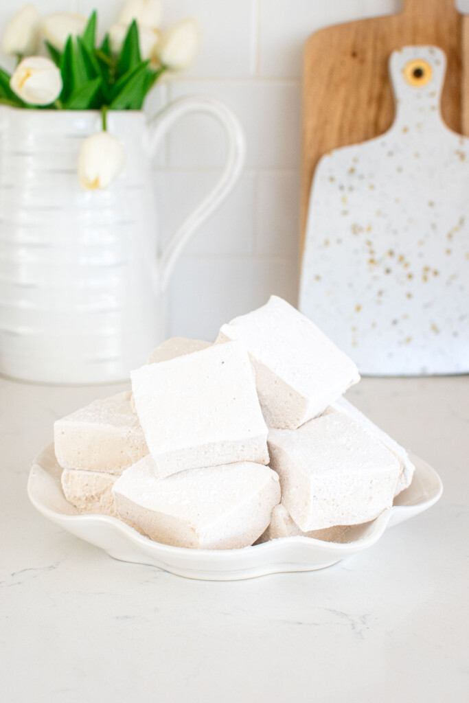 homemade pumpkin spice marshmallows on a plate on the kitchen countertop.