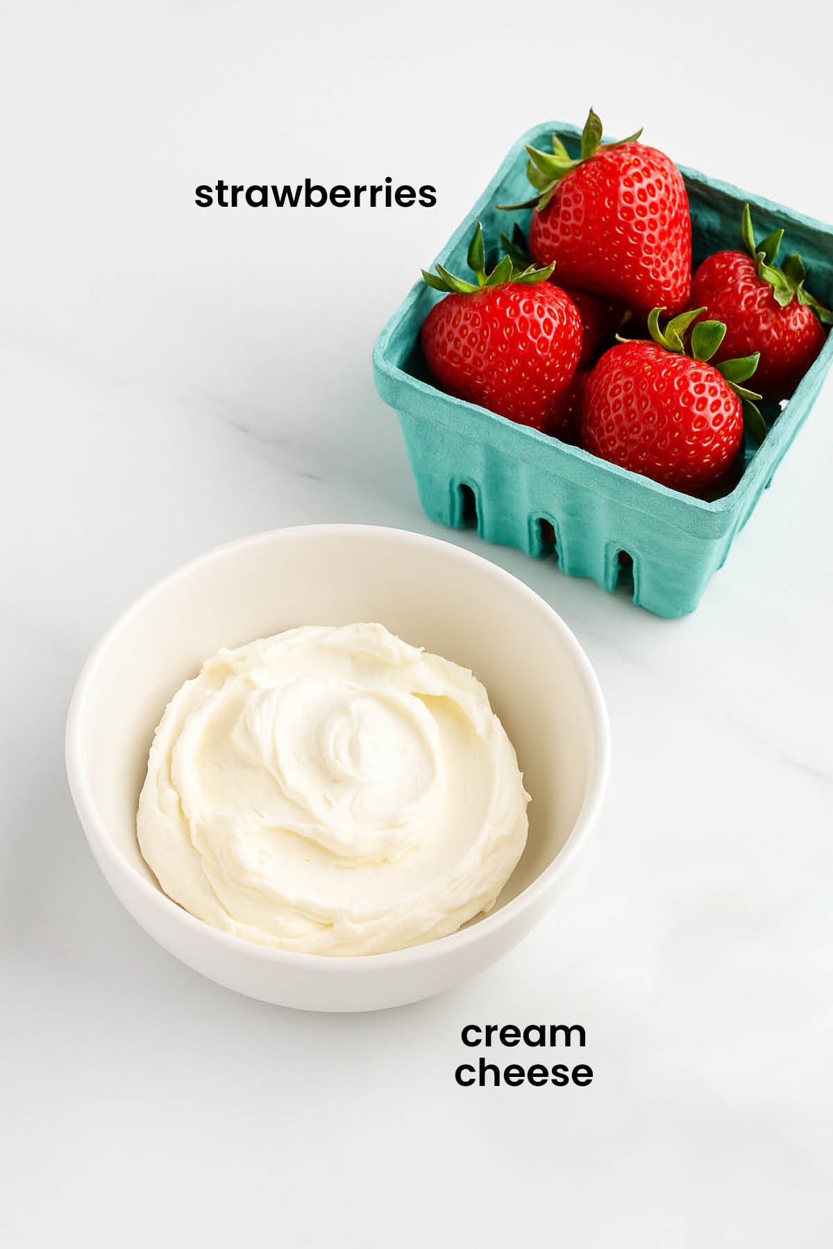 individual ingredients for strawberry cream cheese spread laid out against a white background.