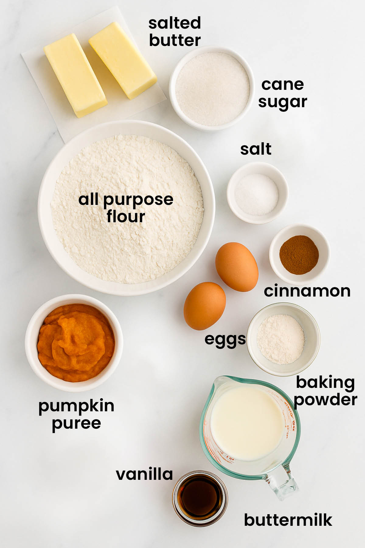 individual ingredients for buttermilk pumpkin waffles laid out against a white background.