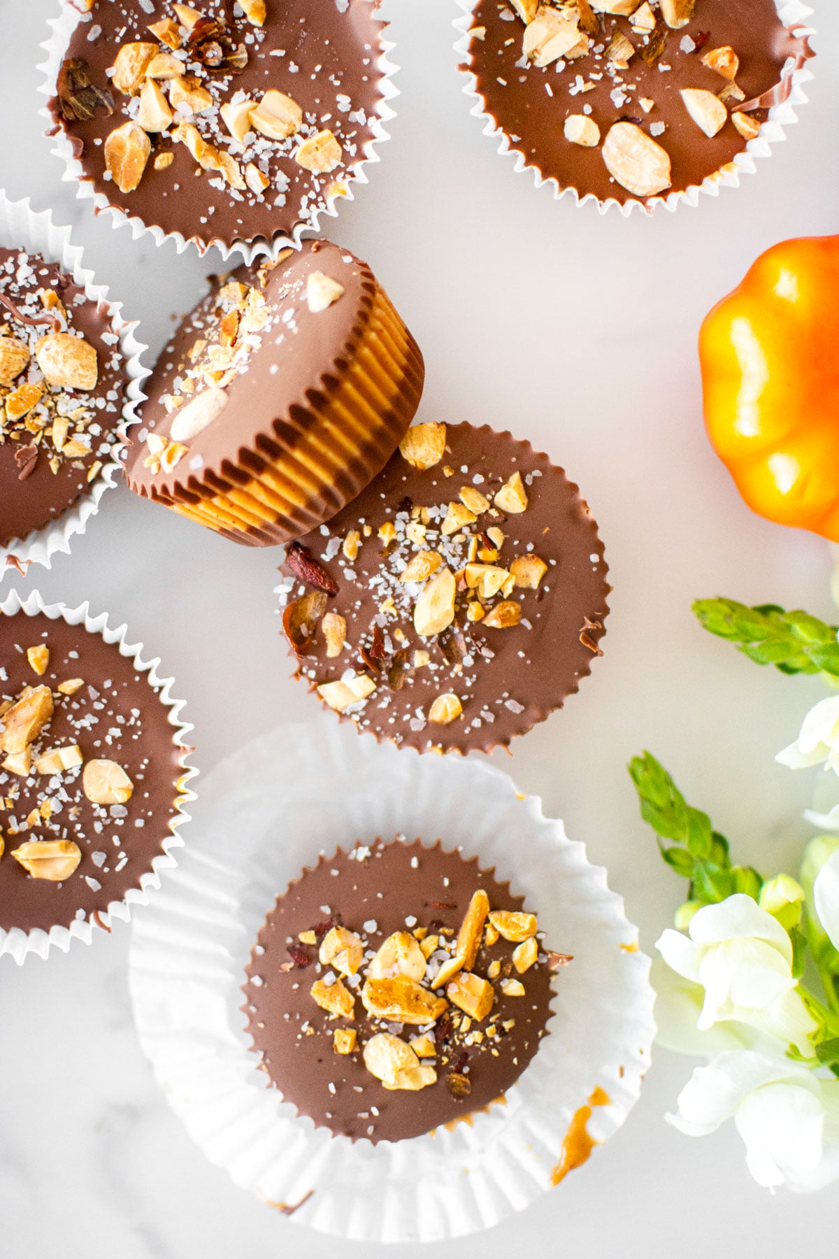 healthy chocolate peanut butter cups on a white marble counter.