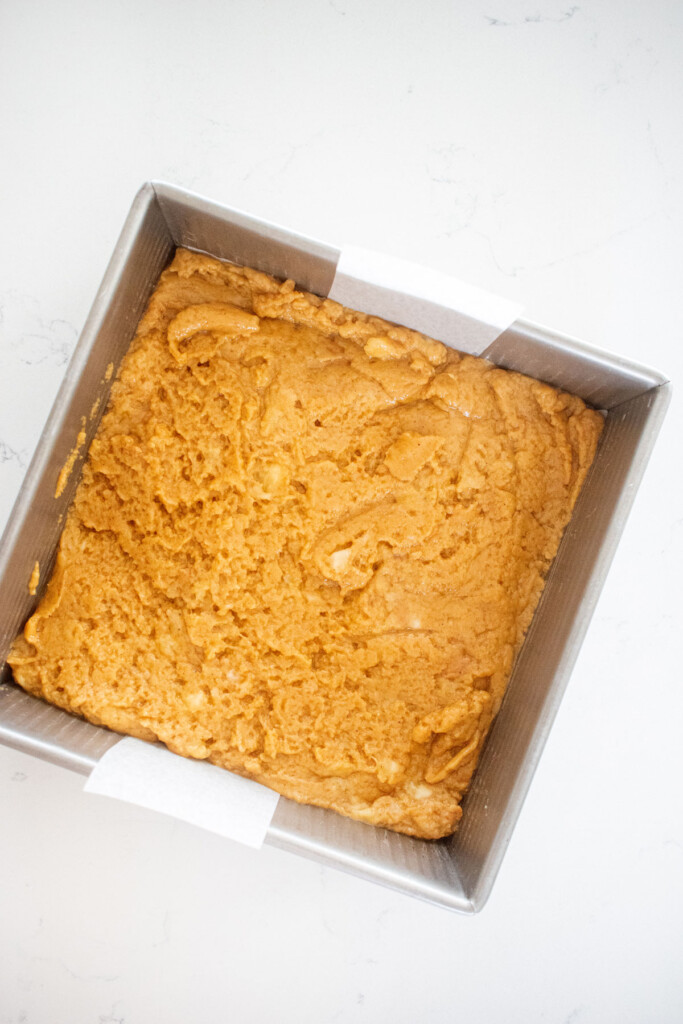 peanut butter banana dog treats in a baking pan on a white marble countertop.