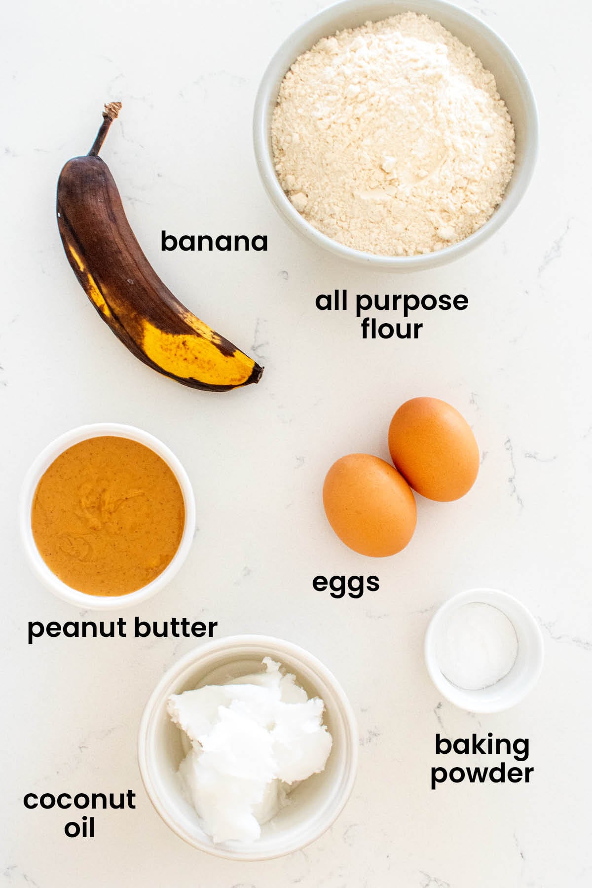 individual ingredients for peanut butter banana dog treats laid out against a white background.