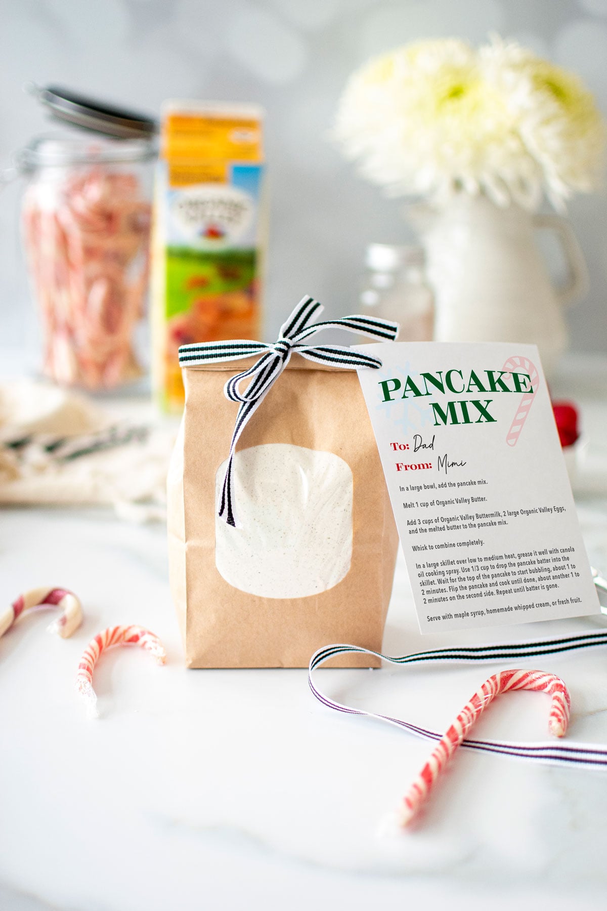 homemade pancake mix in a brown bag with a ribbon and card attached.