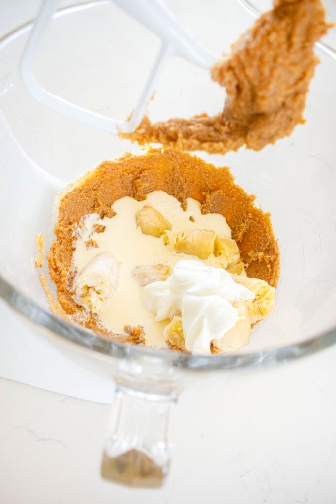wet ingredients for eggless mini chocolate chip banana bread in a glass mixing bowl.