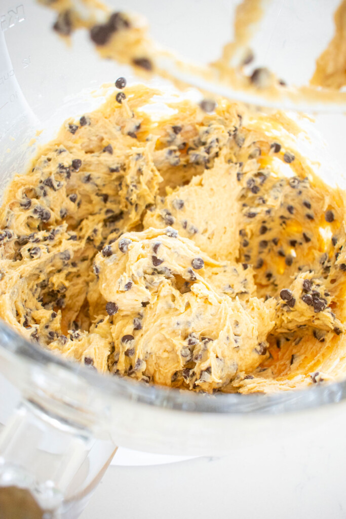 eggless mini chocolate chip banana bread batter in a glass mixing bowl.