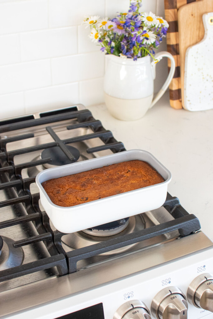 baked eggless mini chocolate chip banana bread cooling on top of an oven.