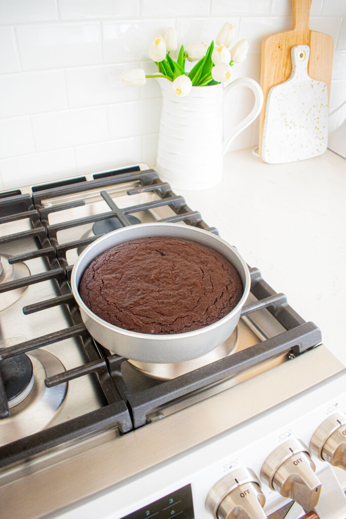 baked pumpkin spice chocolate zucchini cake cooling on the stovetop.
