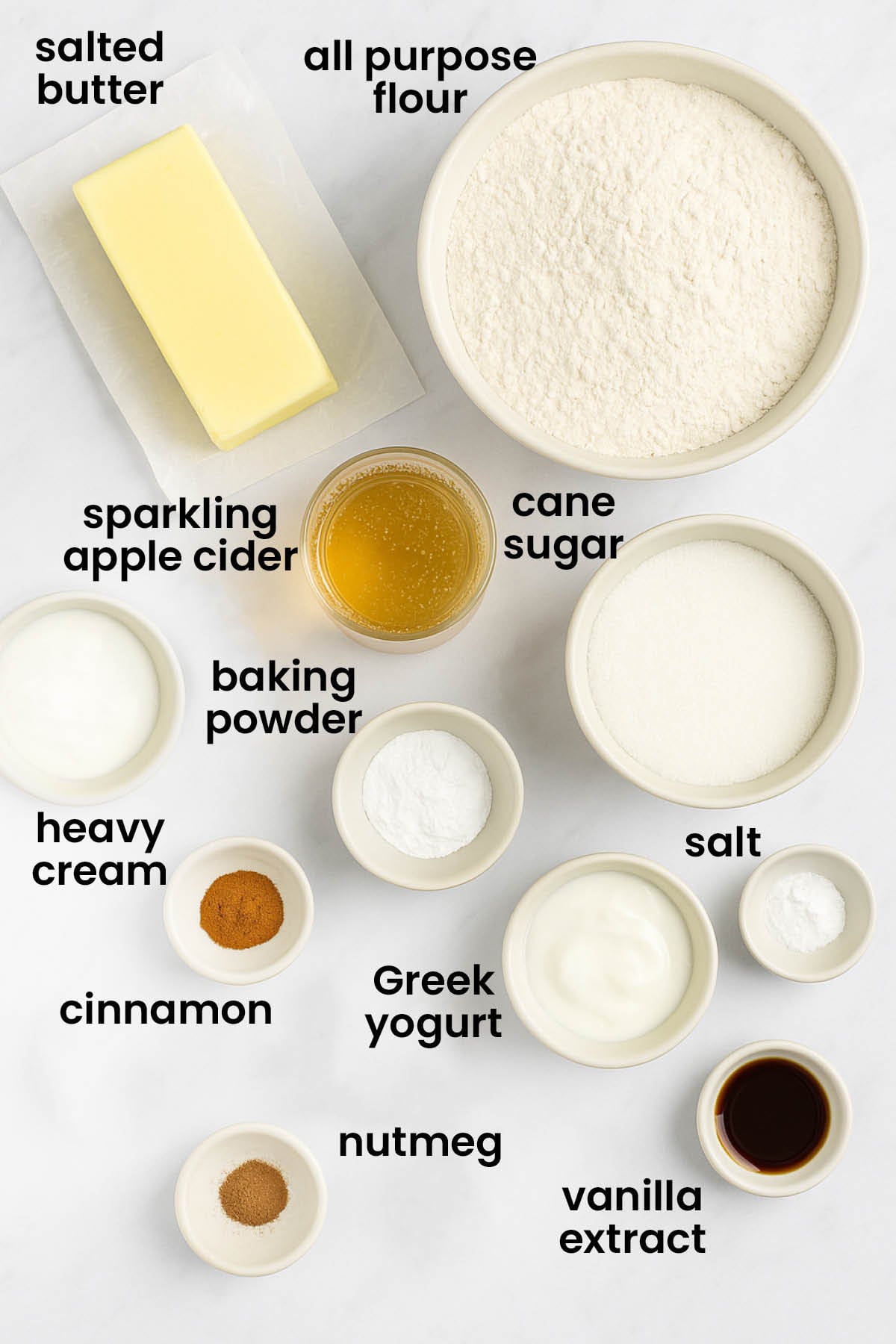 individual ingredients for sparkling apple cider donuts laid out against a white background.