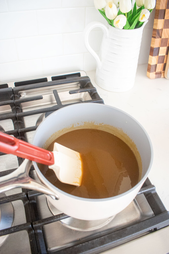 brown butter butterscotch sauce being stirred on the stovetop.