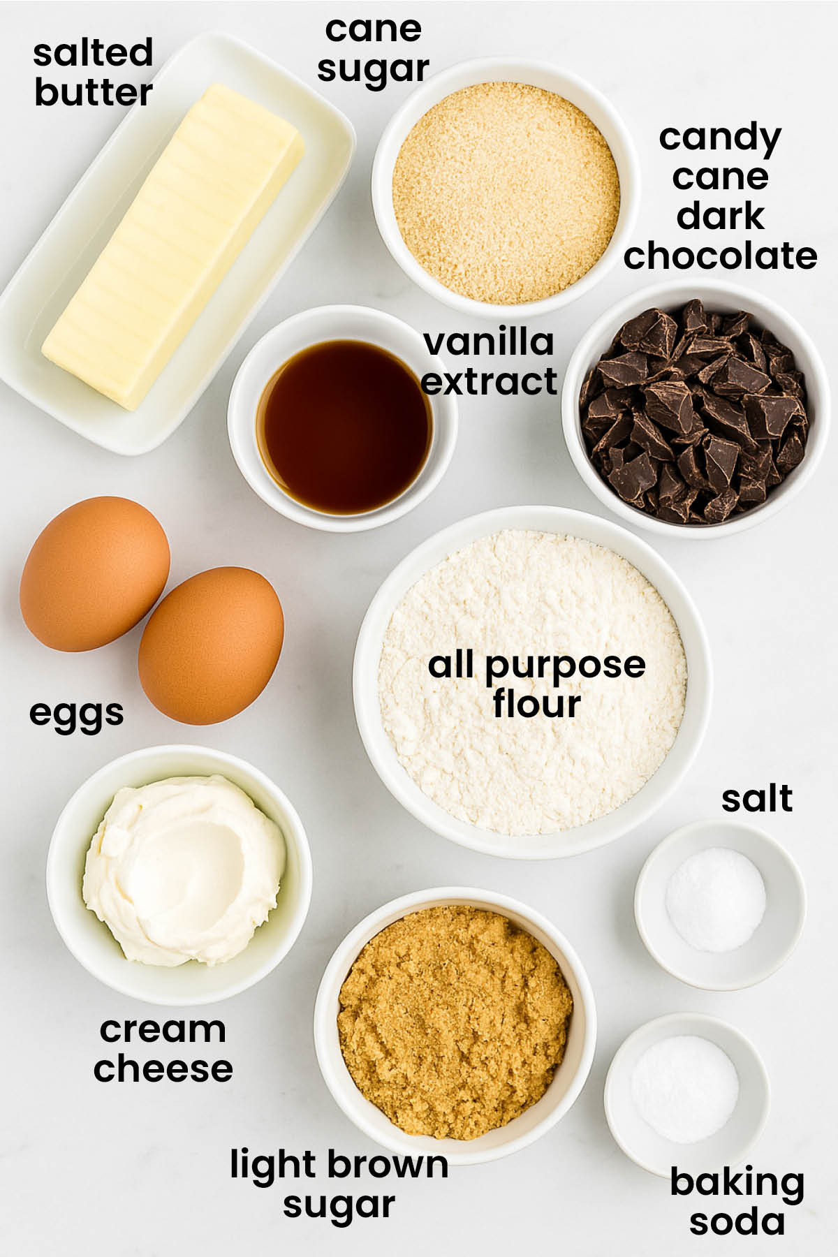 individual ingredients for candy cane crunch dark chocolate cookies laid out against a white background.