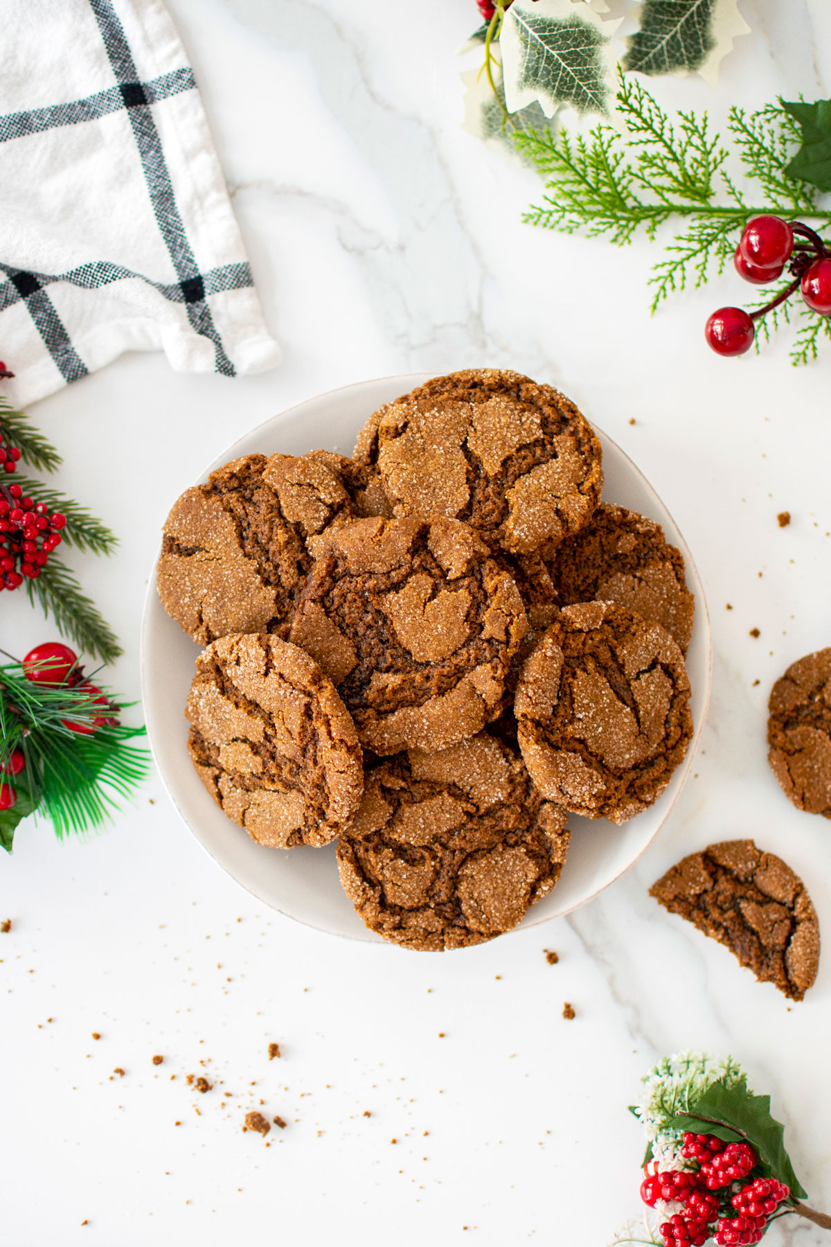 plate of eggless sourdough molasses cookies on a white marble counter.