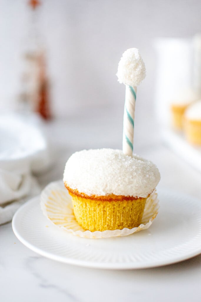 north pole cupcake on a plate with holiday decor on a table.