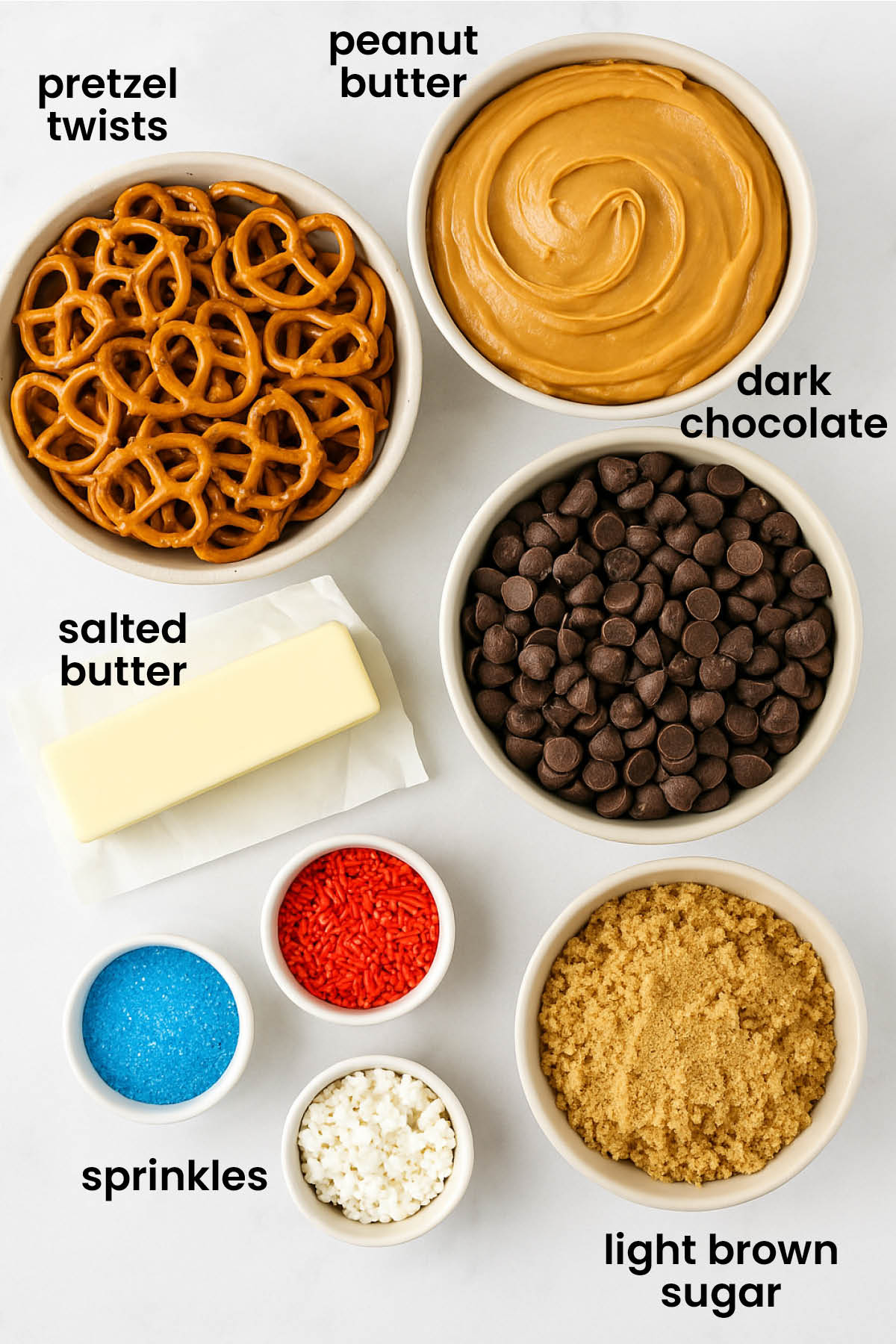 individual ingredients for peanut butter pretzel christmas crack laid out against a white background.