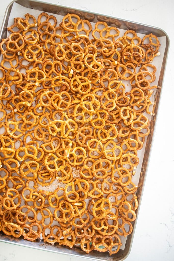 peanut butter pretzel christmas crack on a baking sheet on a marble counter.