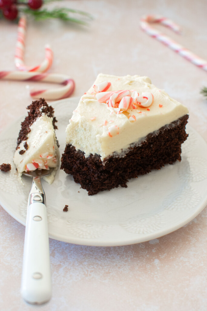 peppermint bark snack cake slice on a plate with a bite taken out.