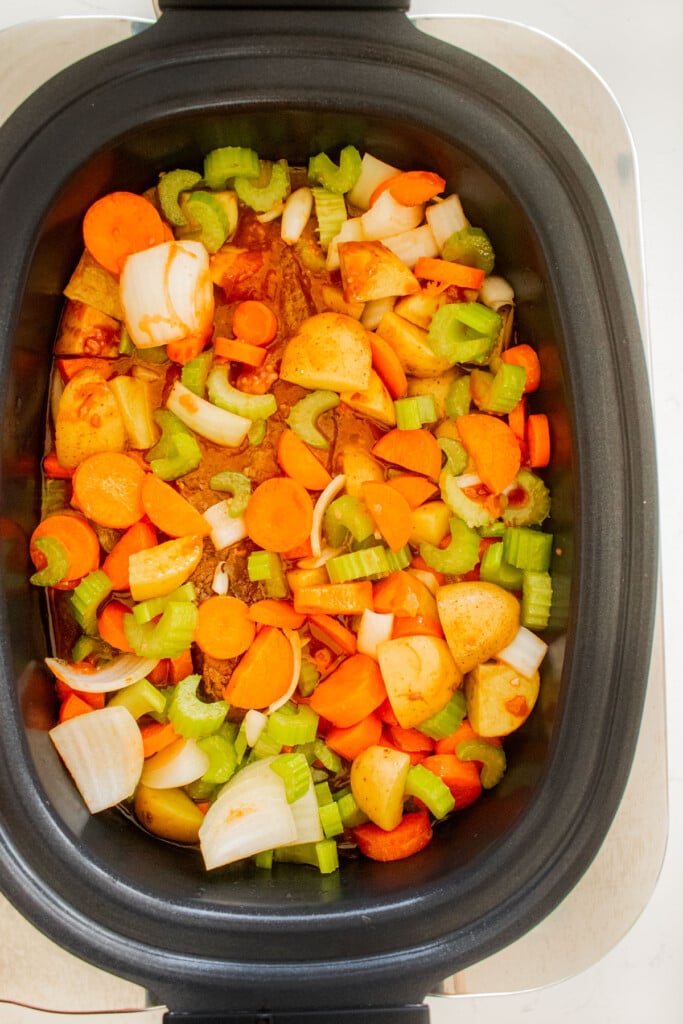 slow cooker beef brisket stew being cooked in a slow cooker.