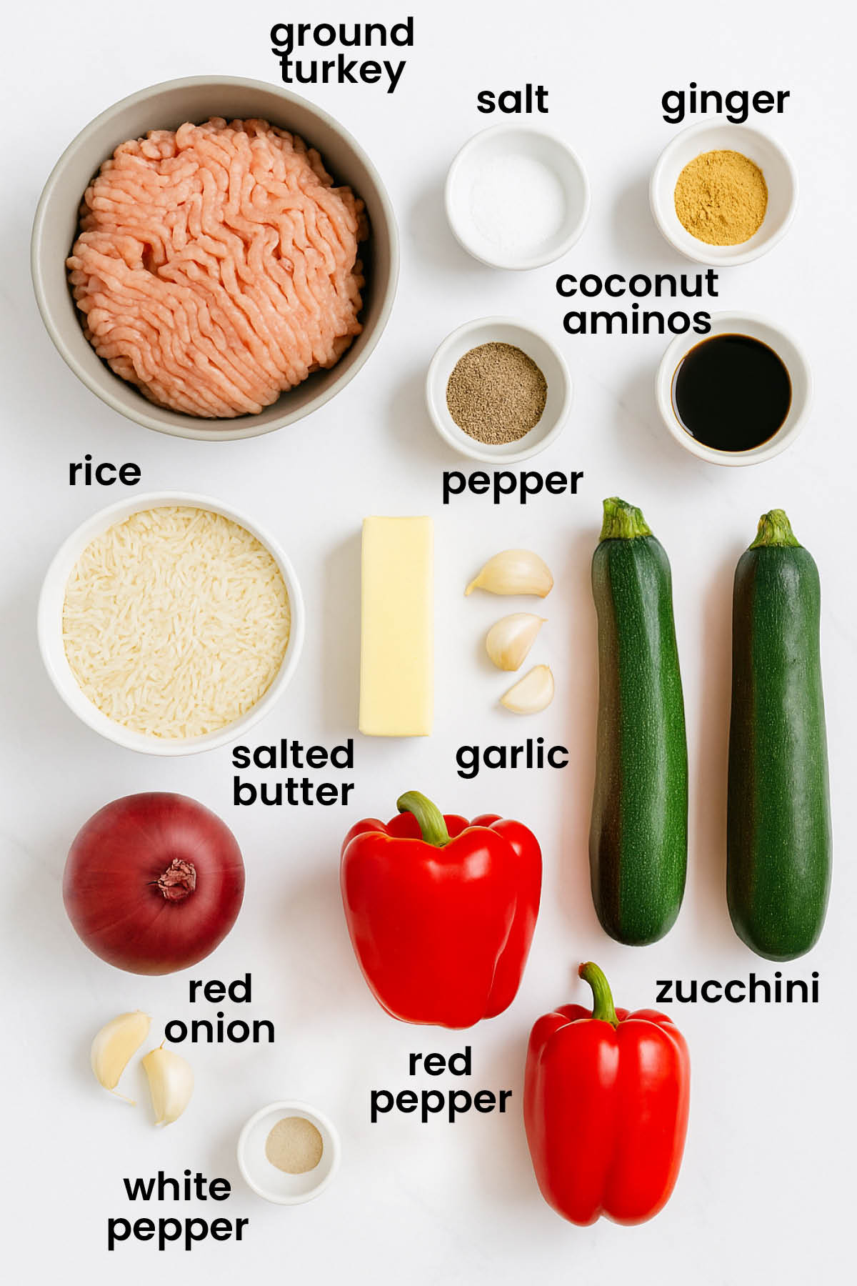 individual ingredients for turkey zucchini red pepper skillet laid out against a white background.