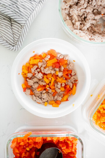 chicken dinner recipe for dogs in a dog bowl on a white marble countertop.