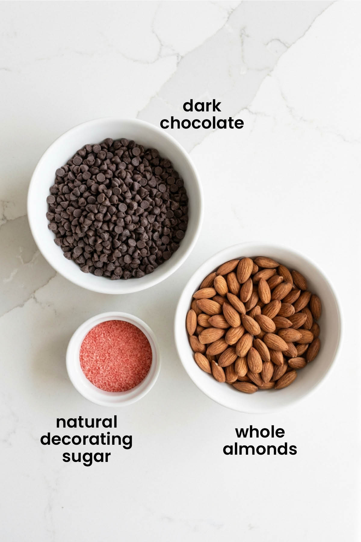 individual ingredients for dark chocolate almond hearts laid out against a white background.