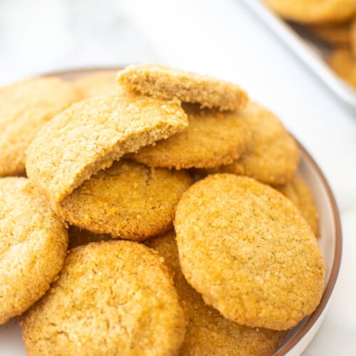 plate of olive oil shortbread cookies on a white marble counter.