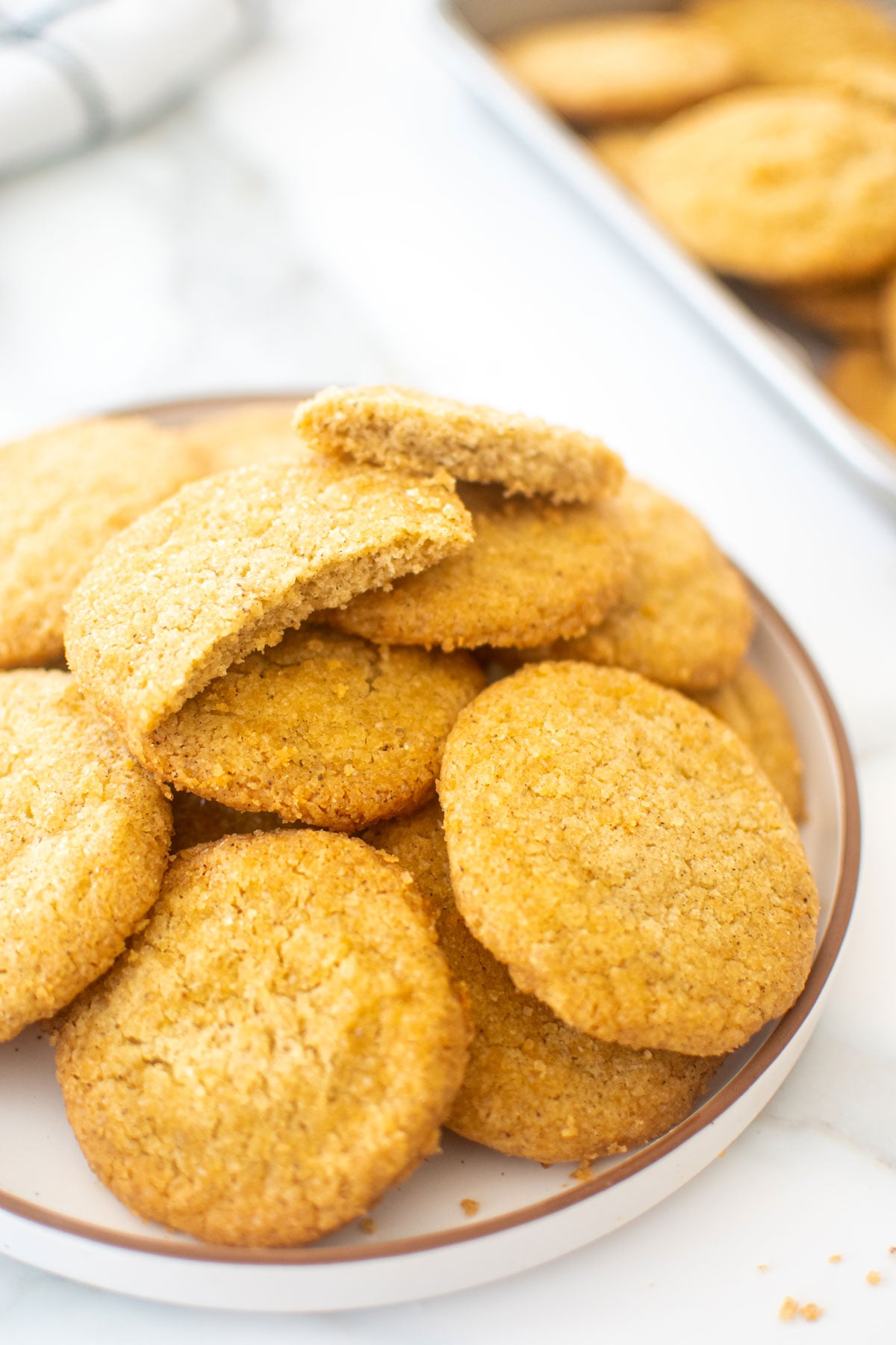 plate of olive oil shortbread cookies on a white marble counter.