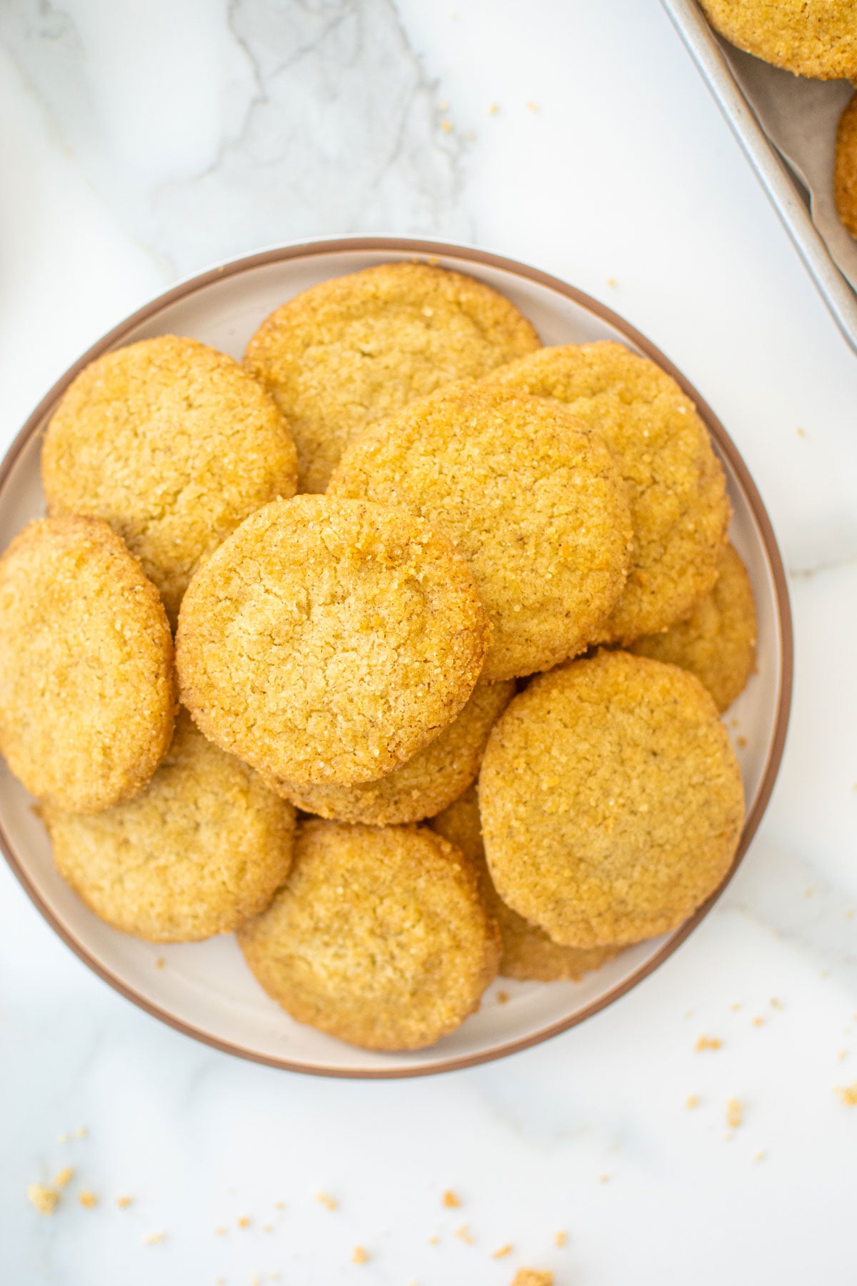 plate of olive oil shortbread cookies on a white marble counter.