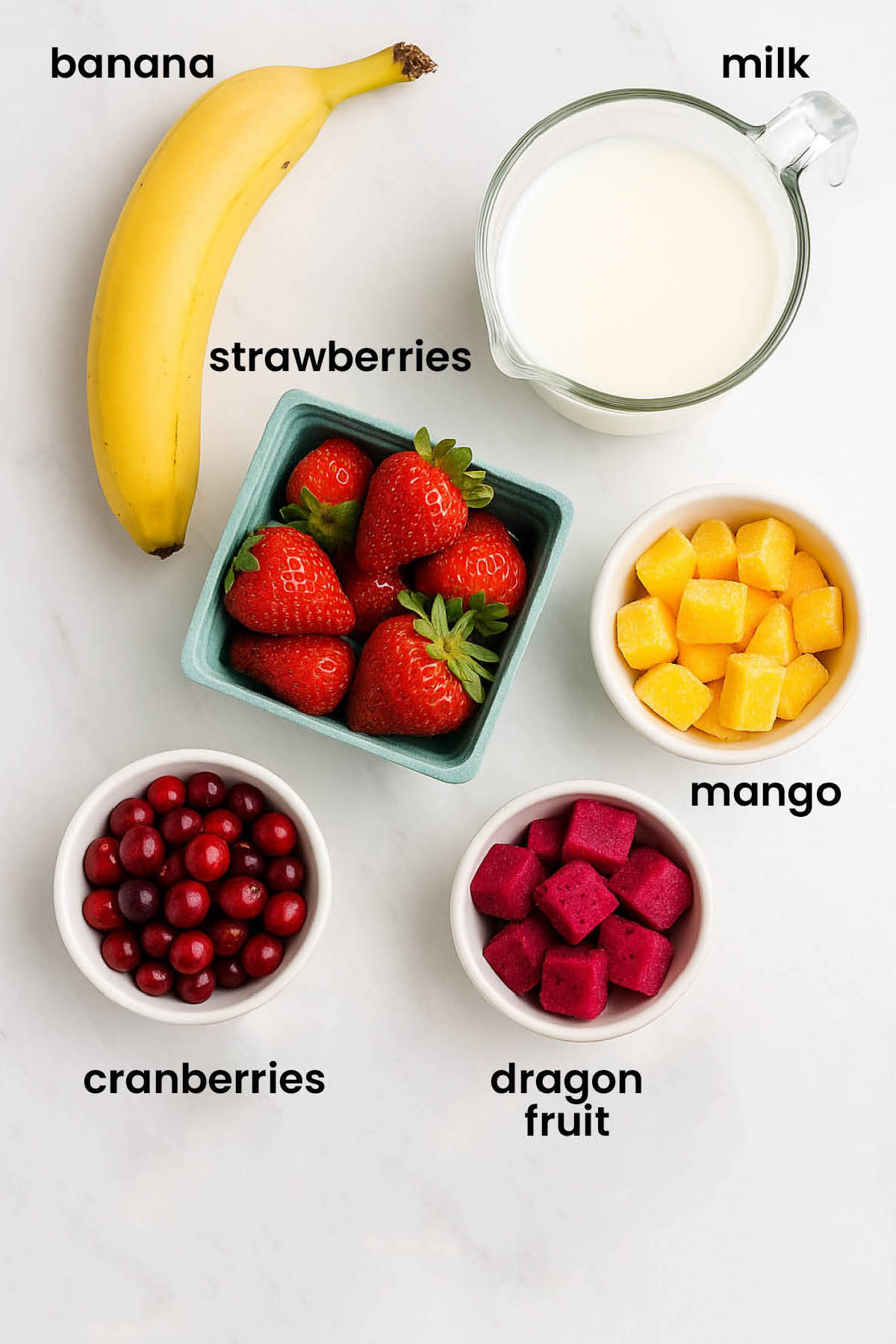 individual ingredients for tropical cranberry smoothie laid out against a white background.