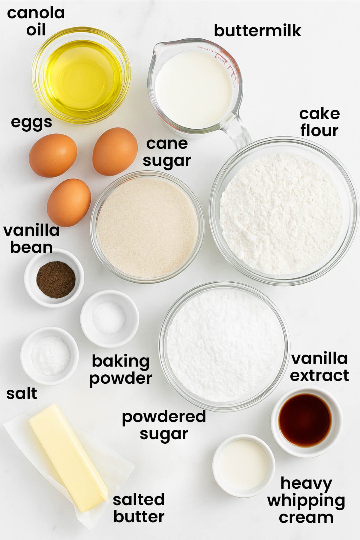 individual ingredients for vanilla buttermilk sheet cake laid out against a white background.