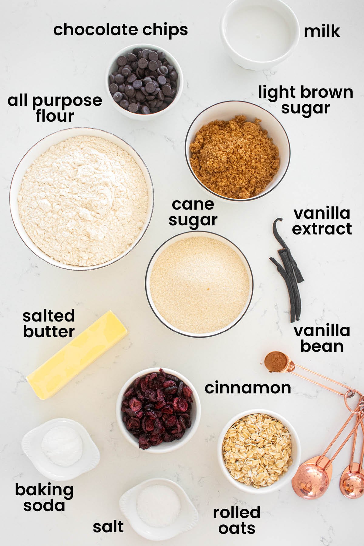 individual ingredients for eggless oatmeal cranberry chocolate chip cookies laid out against a white background.