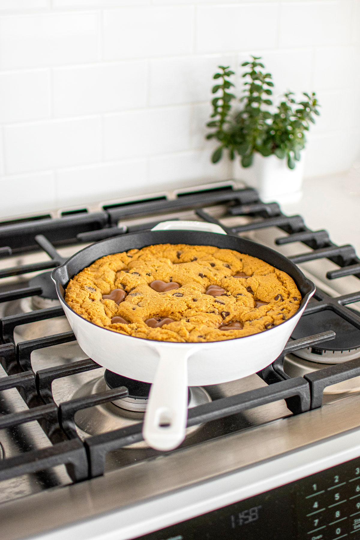 baked valentine's day peanut butter cookie skillet on a stovetop.