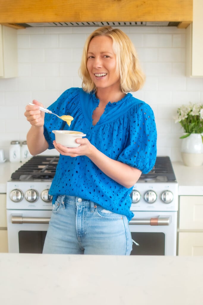 woman in kitchen with a bowl of vanilla malt pudding.